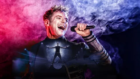 Artist Peter Johansson singing in a microphone